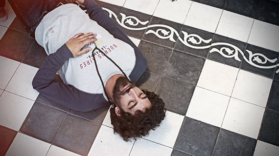 bearded man laying on street