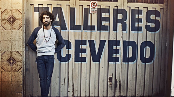 bearded man posing by sign