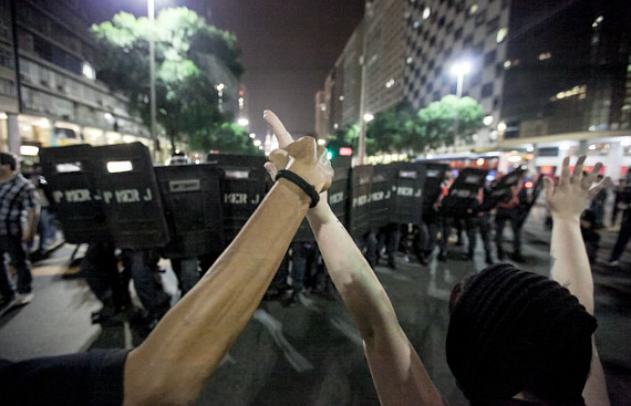 police brazil protest protesters holding hands