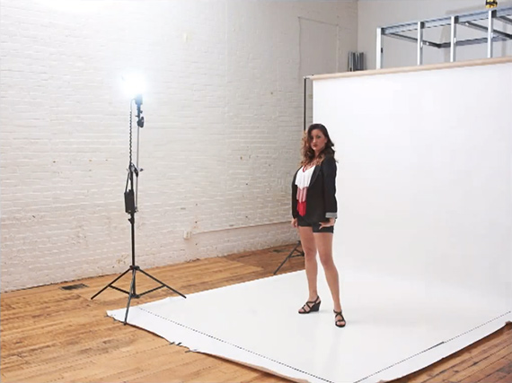 girl posing against backdrop