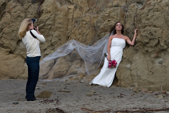 "Female wedding photographer on Morro Strand State Beach, Morro Bay, CA" captured by Mike Baird (Click image to see more from Baird)