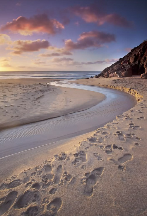 antony spencer low tide water footprints sunset