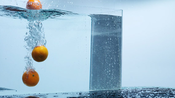 The last part of the shoot required an assistant to drop the oranges into water as Grimm snapped the photos.