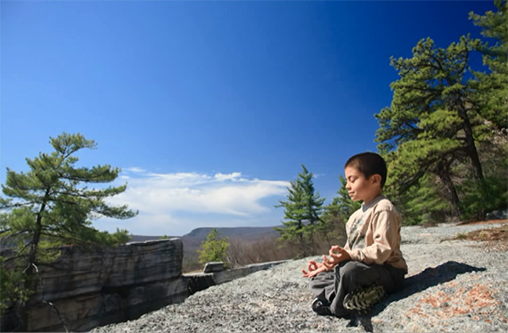 boy-meditating-on-rock