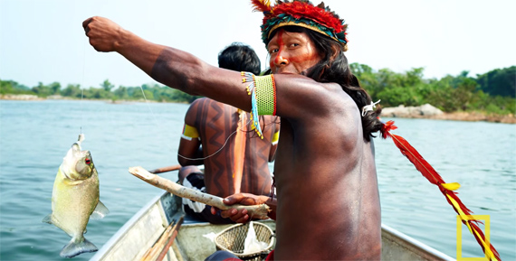 fish fishing hunting amazon brazil jungle rainforest canoe boat headdress 