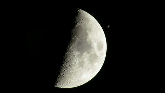 A moment befoe the ISS wheezes past the moon