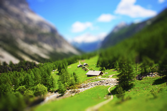 tilt shift image of cabins in mountains