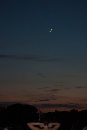 person in foreground of lunar photo