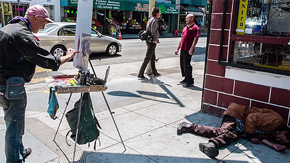 painter paints homeless man photo