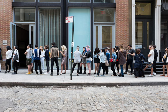 people waiting in line street photography