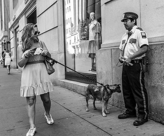 woman dog security guard street portrait