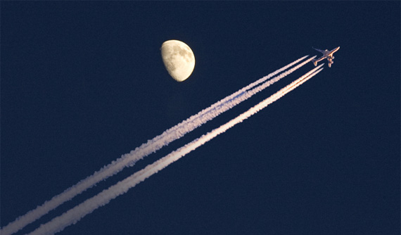 plane flying past moon