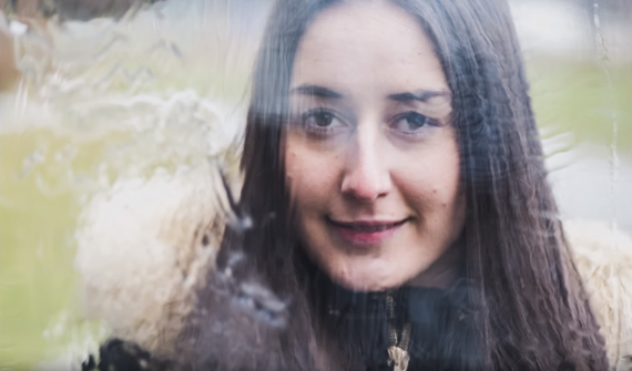 model behind water distorted glass