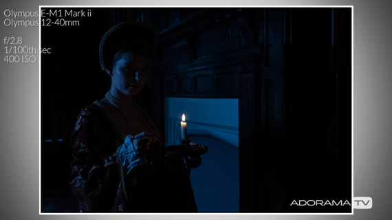 dark image of model with candle lit