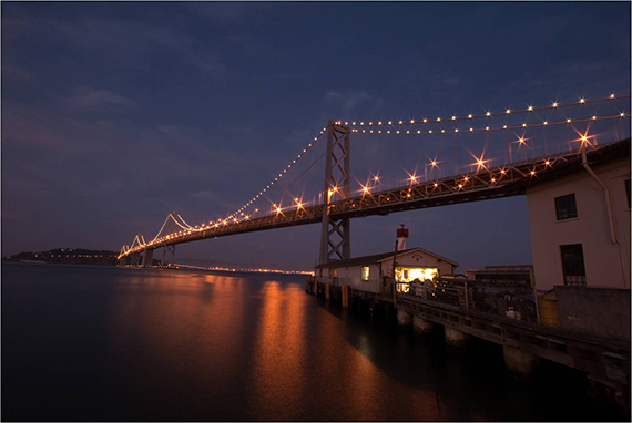 bridge lit up in the evening