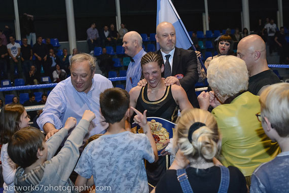 crowd around winning boxer